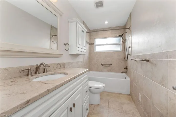 2nd Full bathroom featuring vanity, tiled shower / bath combo, tile patterned floors
