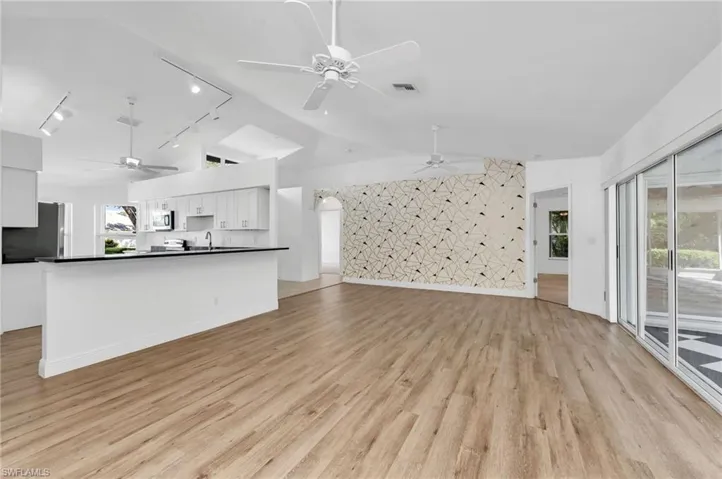 Living room with light vaulted ceiling