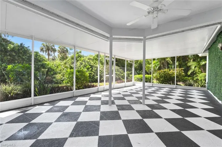 Screened in lanai featuring a healthy amount of sunlight and ceiling fan