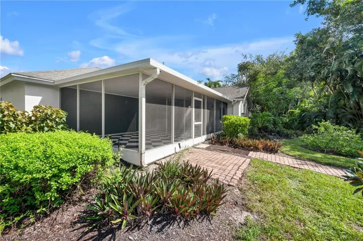 Back of property with a sunroom