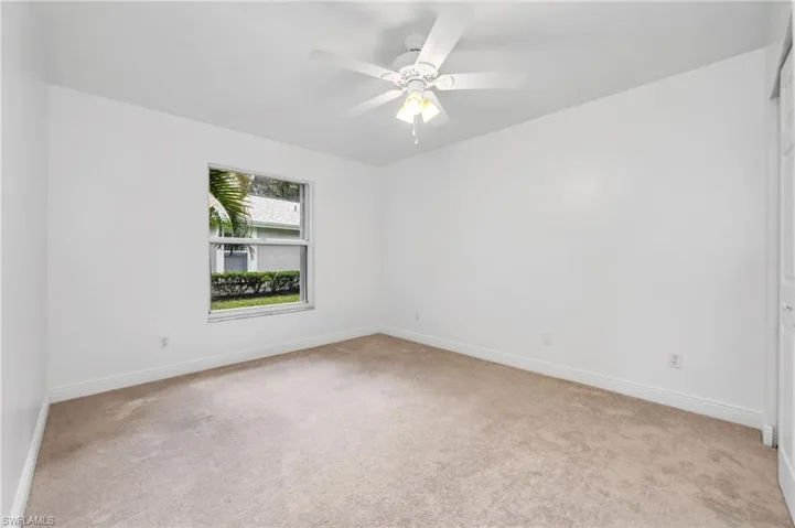 3rd bedroom featuring ceiling fan and light carpet