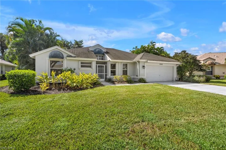 Single story home featuring a 2 car garage and a large front yard