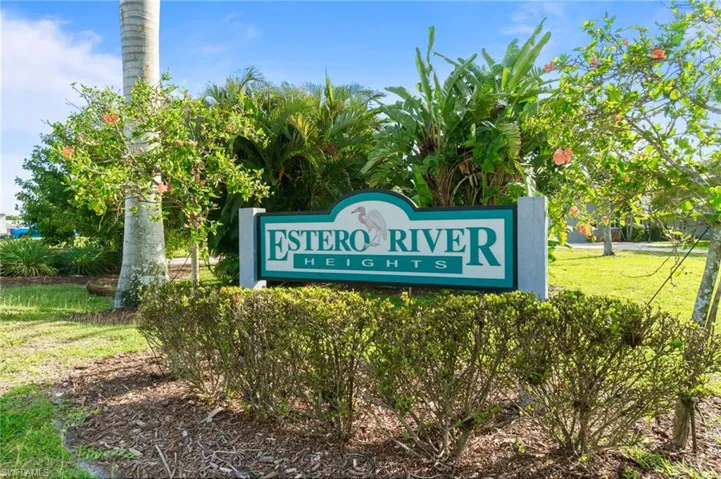 Community entrance with welcoming signage and well maintained landscaping