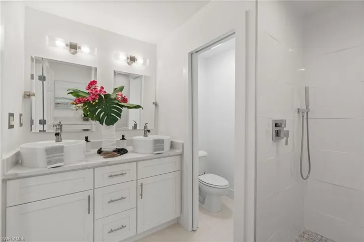 Updated bathroom with dual vanity and modern fixtures