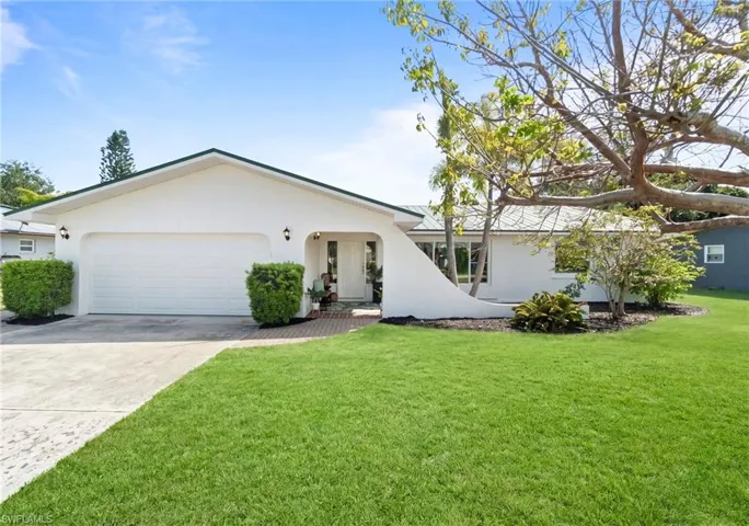 Well maintained exterior with spacious driveway and manicured lawn