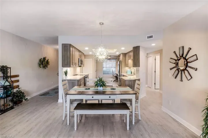 Dining area featuring a chandelier and light wood-type flooring