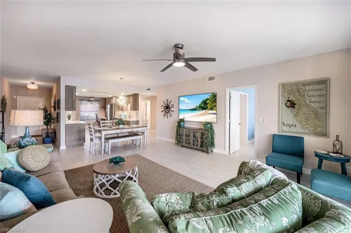 Living area with woodlook tile finished floors and a ceiling fan