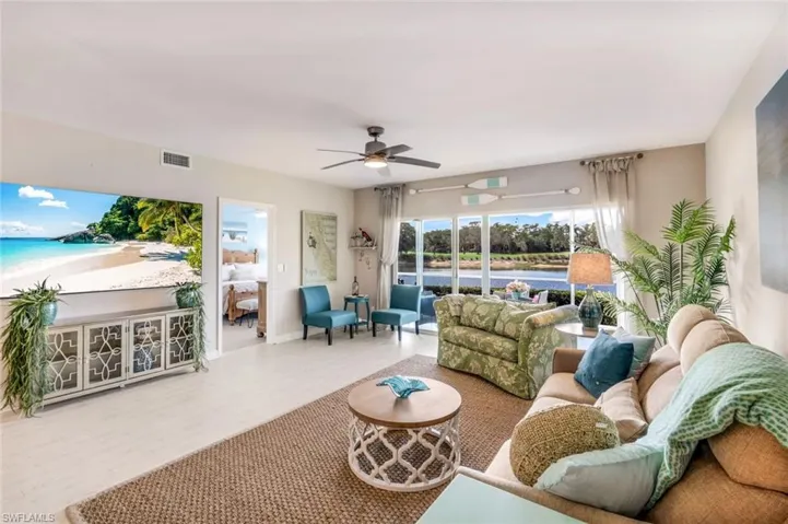 Living room with ceiling fan and wood finished floors