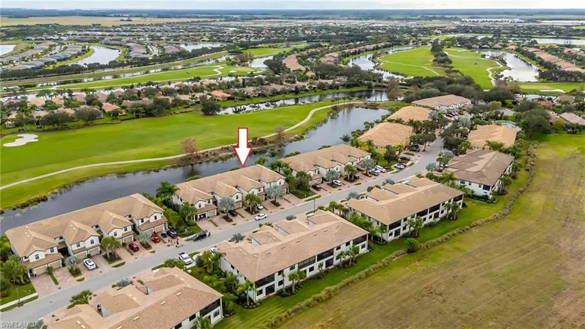Aerial view of property and surrounding area with a local golf course and nearby suburban area