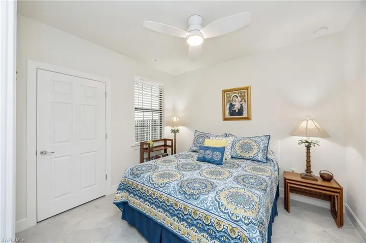 Bedroom 2 with a ceiling fan and light tile patterned flooring