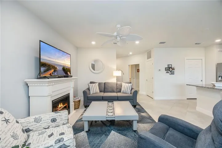 GREAT ROOM featuring a glass covered fireplace, recessed lighting, and ceiling fan