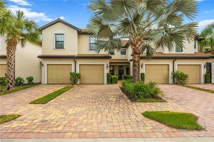 fIRST FLOOR CONDO/CARRIAGE HOME with an attached garage, and a tiled roof