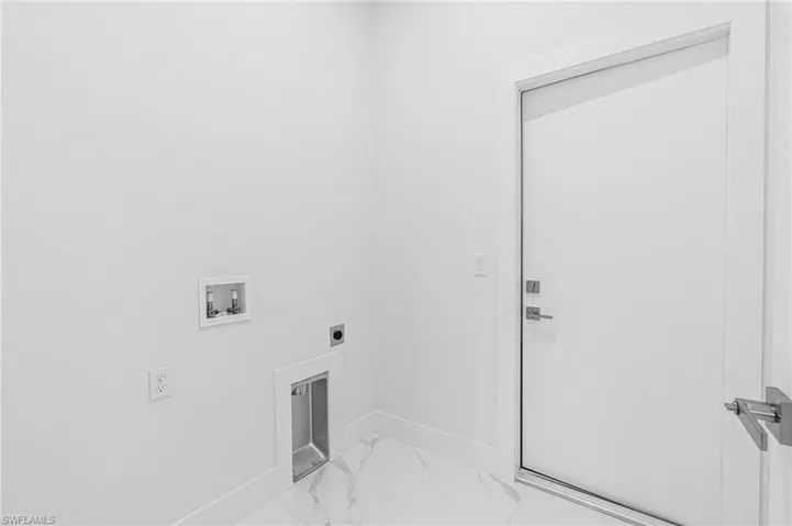 Laundry room with marble finish flooring, hookup for an electric dryer, and hookup for a washing machine