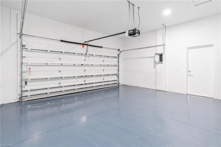 Garage with electric panel and a garage door opener