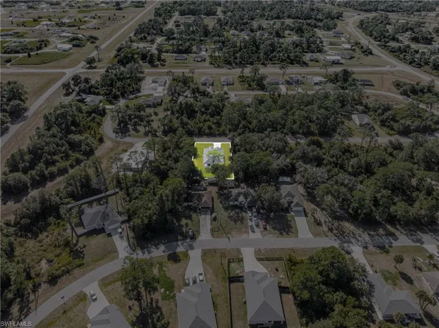 Aerial overview of property's location with nearby suburban area