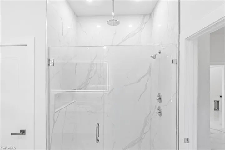 Full bathroom with a marble finish shower