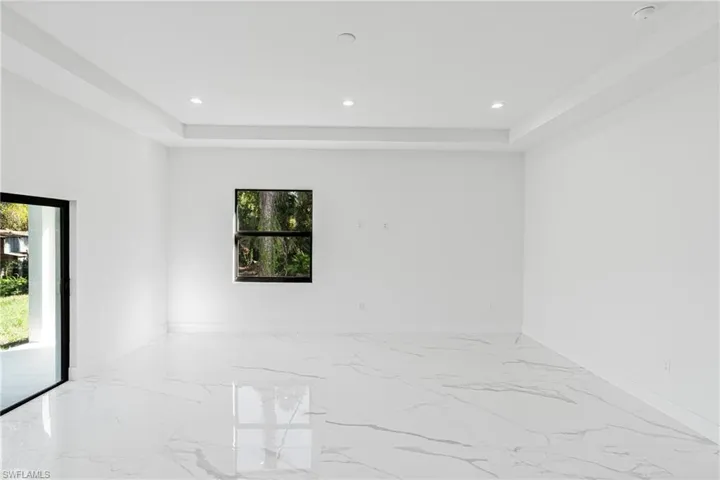 Spare room with marble tiled floors and recessed lighting