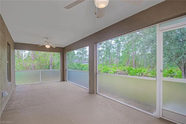 Unfurnished sunroom featuring ceiling fan and a wealth of natural light