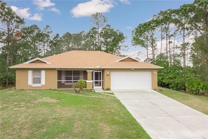 Ranch-style house with a garage and a front yard