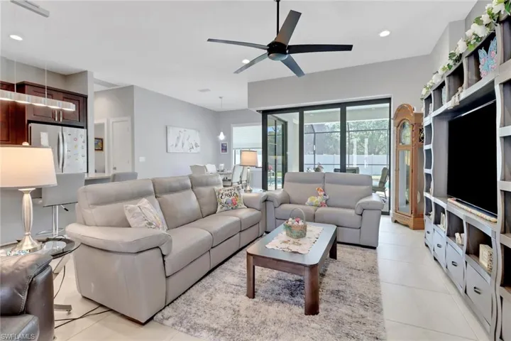 Living room featuring ceiling fan, recessed lighting, and light tile patterned floors
