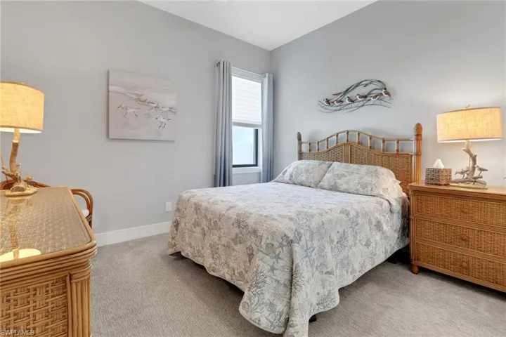 Carpeted bedroom featuring baseboards