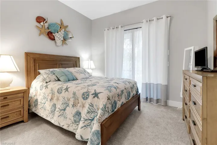 Bedroom with baseboards and light carpet