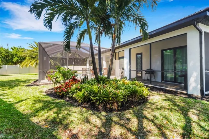View of yard with a lanai and fence