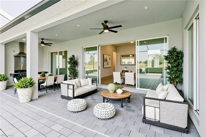 View of patio / terrace featuring outdoor dining area, an outdoor living space, and a ceiling fan