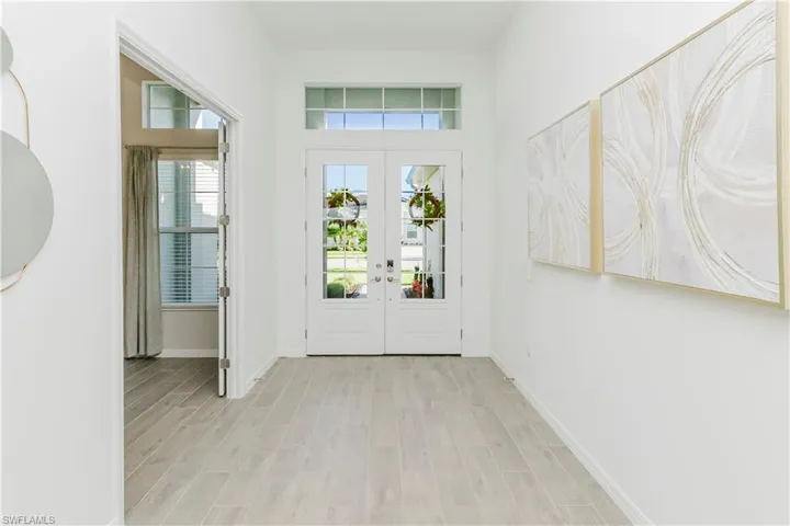 Doorway to outside with wood finish floors and french doors