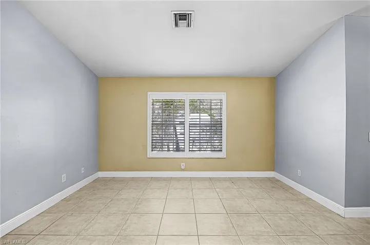 Spare room with baseboards and light tile patterned floors