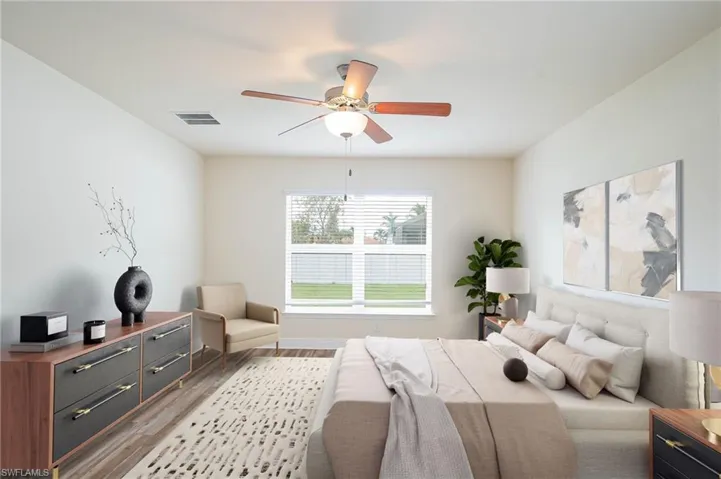 Bedroom featuring ceiling fan, light wood-style flooring, and visible vents