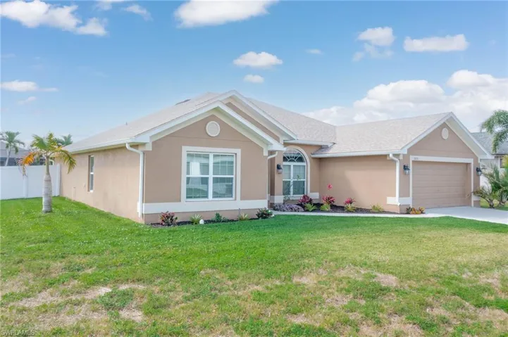 Single story home with a garage, a front lawn, concrete driveway, and stucco siding
