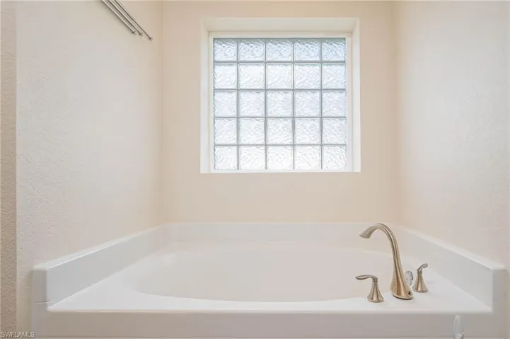 Full bath featuring a soaking tub