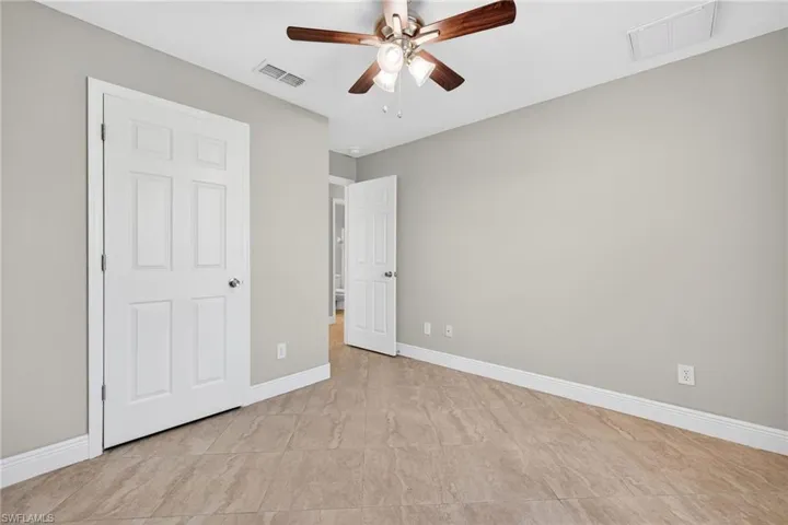 Unfurnished bedroom featuring baseboards and a ceiling fan