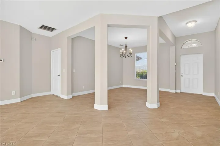 Entryway featuring a chandelier and light tile patterned flooring