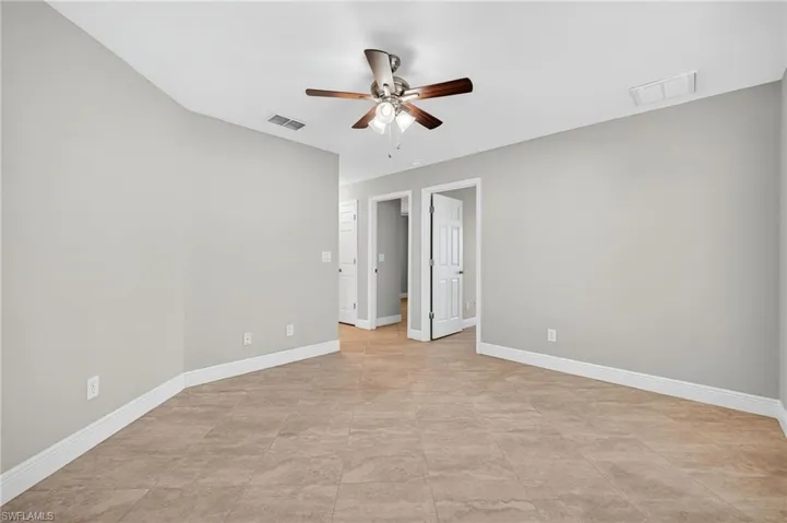 Unfurnished bedroom featuring baseboards and ceiling fan