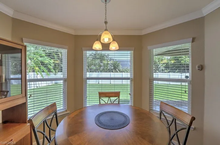 Dining room with a healthy amount of sunlight and ornamental molding