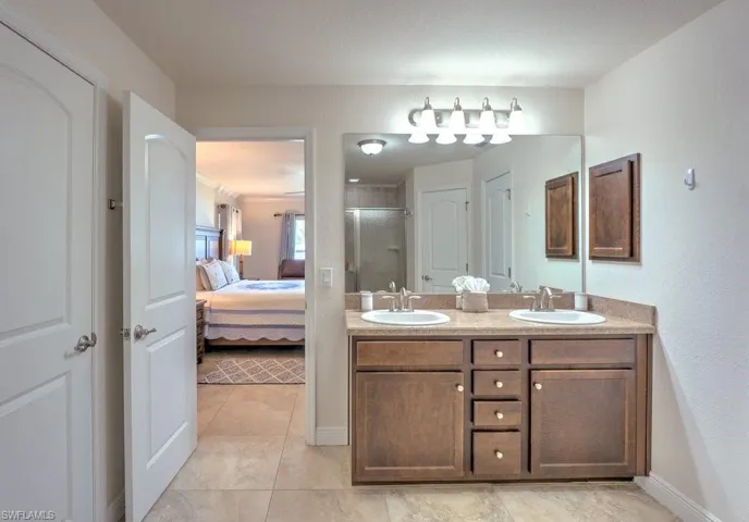 Bathroom featuring dual vanity and tile patterned flooring