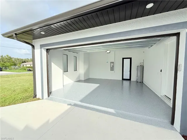 Garage with water heater and electric panel