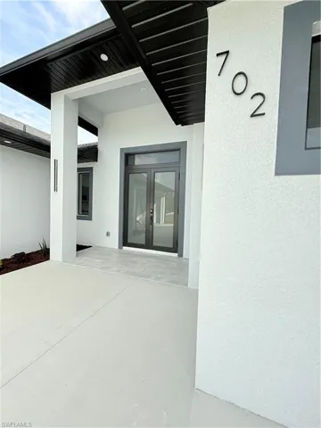 Entrance to property with french doors and stucco siding