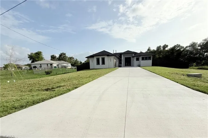 View of front of property featuring concrete driveway