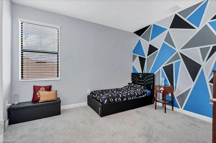 Living area with baseboards and carpet