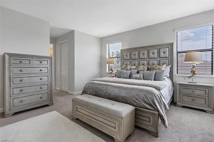 Bedroom featuring light carpet and a closet