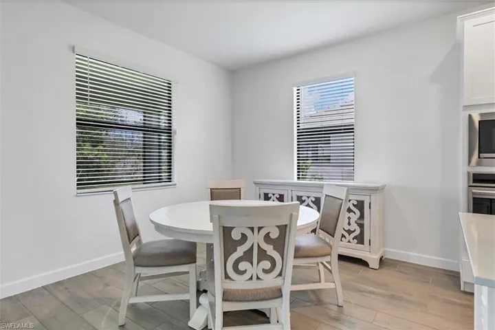 Dining area featuring light wood-type flooring and baseboards