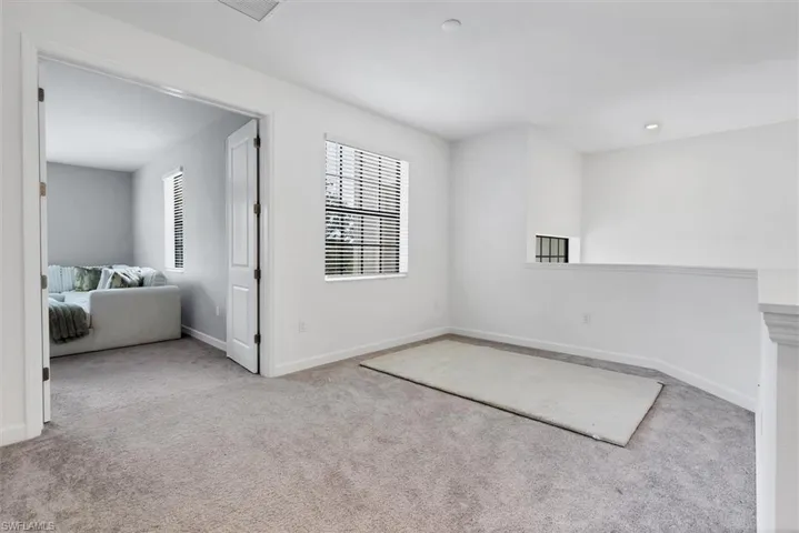 Spare room with light colored carpet and recessed lighting