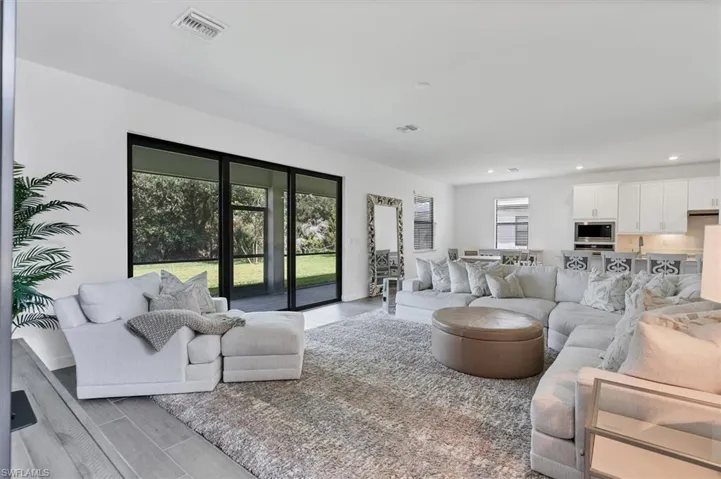 Living room featuring wood finished floors and recessed lighting