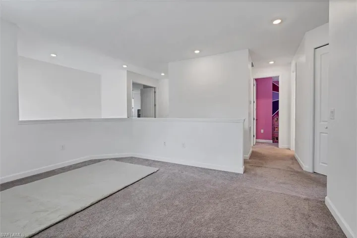 Carpeted empty room with recessed lighting