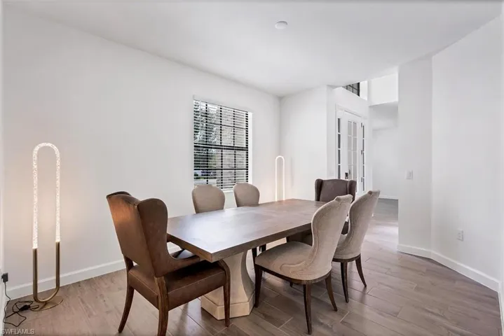 Dining area featuring light wood finished floors and french doors
