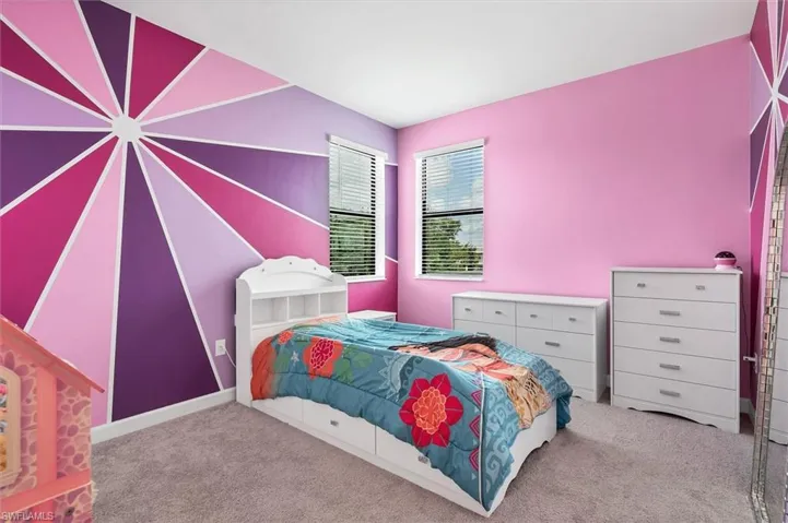 Carpeted bedroom with baseboards