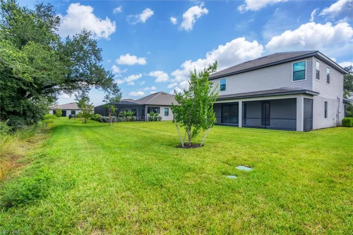 Back of property featuring a yard and a sunroom